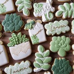 many decorated cookies are arranged on a wooden table with the words sweet as tea and succulents