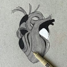 a pen is laying on top of a drawing