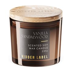 a candle that is brown and white with a label on the lid reads vanilla sandalwood scented soy wax candle