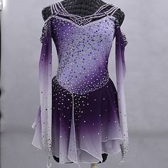 a purple and white figure skating dress on display