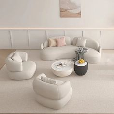 a living room with white couches and chairs in the middle of carpeted flooring