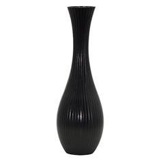 a tall black vase sitting on top of a white table next to a light bulb