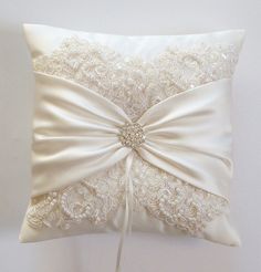 a white pillow with a bow on it