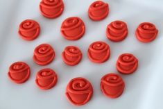 red icing with swirls on white background for cake decorating or fondant