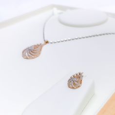 Make a statement with this chic rose gold diamond pendant set. Featuring a stunning pendant with 1.36ct round brilliant cut diamonds and matching earrings, this set is perfect for any stylish occasion. Crafted with 18k rose gold, this set weighs 7.8 grams and boasts an impressive pendant length of 1.5". The diamonds are of F-G color and VS quality, adding the perfect sparkle to this already stunning piece. PRODUCT DETAILS Gold Purity(karat): 18k Gold Weight(grams): 7.8 Item Finish: Rose Gold Sto Dazzling Rose Gold Diamond Jewelry Sets, Elegant Rose Gold Diamond Jewelry Sets, Elegant Rose Gold Jewelry Sets With Diamond Accents, Rose Gold Pendant Set, Diamond Pendant Set, Gold Pendant Set, Diamond Pendant Sets, Rose Gold Pendant, Rose Gold Diamonds