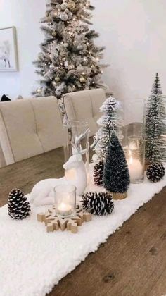 a dining room table decorated for christmas with pine cones and candles