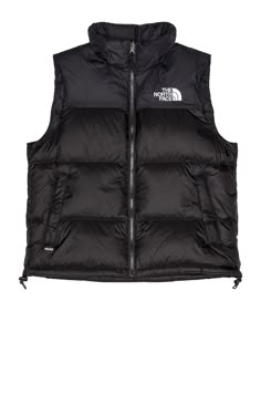 Find THE NORTH FACE 1996 Retro Nuptse Vest In Black on Editorialist. The North Face 1996 Retro Nuptse Vest in Black Self & Lining: 100% nylon Fill: 85% down 15% waterfowl feathers. Made in Bangladesh. Machine wash. Front zipper closure. Side zip pockets. Drawcord fastening at hem. Embroidered logo detail at chest. Mid-weight fabric. TACF-MO74. NF0A3JQQLE41. About the designer: Black Windproof Outerwear For Adventure, Black Casual Adventure Outerwear, Black Casual Outerwear For Adventure, Casual Black Outerwear For Adventure, Black Winter Outerwear For Adventure, Black Winter Adventure Outerwear, Black Nylon Outerwear For Adventure, Updated Closet, Black North Face Puffer