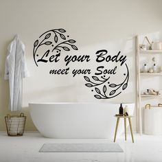 a bathroom with a tub and wall decal that says let your body meet your soul