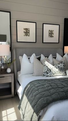 a bedroom with two framed pictures above the bed