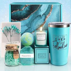 a blue gift box with candles, teal items and cards