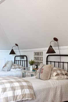 two beds in a room with white walls