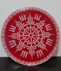 a red plate with white designs on it