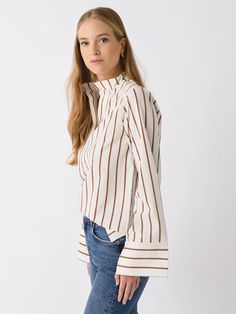 DESCRIPTION:An oversized striped shirt featuring a high band collar, split neckline, and long wide sleeves.FEATURES:Band CollarSplit NecklineWide SleevesAll-Over Stripe Print88% Viscose, 12% PolyamideRelaxed FitModel is wearing size Small shirt.Model's Measurements: Height: 5'9.5" | Bust: 32C | Waist: 26.5" | Hips: 37" | Dress Size: 2-4 (US) Fall Daywear Shirt With Striped Collar, Fall Season Striped Collar Shirt For Daywear, Beige Long Sleeve Tops With Striped Collar, Collared Tops With Vertical Stripes For Fall, Striped Blouse For Workwear In Fall, Spring Striped Long Sleeve Blouse, Fall Striped Blouse For Work, Spring Blouse With Striped Long Sleeves, Spring Long Sleeve Blouse With Striped Sleeves