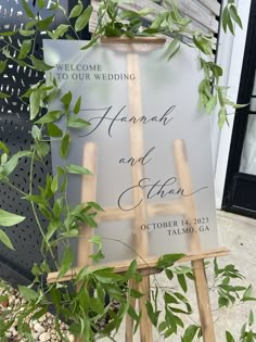 a wooden easel holding a sign that says, welcome to our wedding