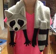 a person wearing a raccoon costume with gloves on