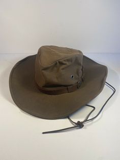 Vintage Outback Trading Company Kodiak Oilskin Hat Brown Size? Western Style. Please ask if measurements are needed no tags for sizing. Brown Military Brimmed Hat, Adjustable Vintage Brown Hats For Outdoors, Vintage Adjustable Khaki Hat, Rugged Brown Hunting Hat, Vintage Khaki Brimmed Hat, Vintage Brimmed Khaki Hat, Vintage Hats With Short Brim For Outdoor Activities, Rustic Brown Hunting Hat, Military Brown Hat For Outdoor Activities