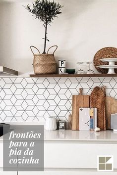 a kitchen with white cabinets and tiled backsplash, wooden cutting boards on the counter