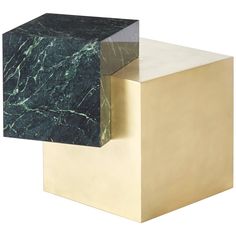 two gold and green marble cubes sitting side by side on top of each other