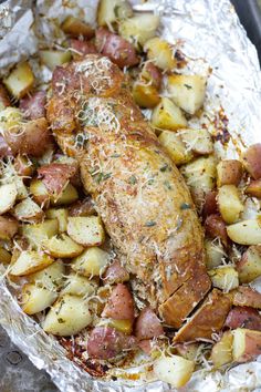 baked chicken and potatoes in foil with parmesan sprinkles