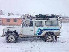 an off road vehicle is parked in the snow