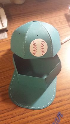 the baseball hat is made out of paper and has a stitched pattern on it