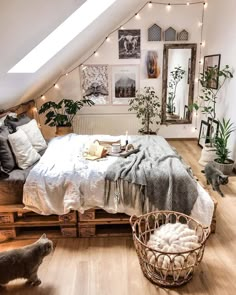 an attic bedroom with white walls and wooden flooring is furnished with natural materials such as wood pallets