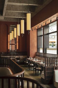 an empty restaurant with wooden tables and chairs