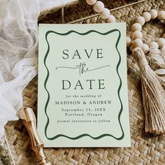 save the date card with tassels and beads on it next to other items