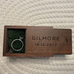 a wooden box with a ring inside it