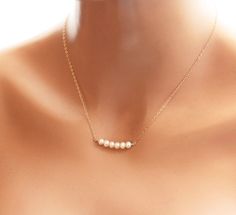 "The most dainty & delicate necklace, perfect for an everyday piece... also perfect as a layering necklace.. I wire wrapped a tiny row of petite swarovski pearls (5mm) in gold filled wire and suspended it from the most delicate & shimmering 14k gold fill flat cable chain. A round spring clasp completes this necklace. Standard length is 18 inches (as pictured). ♥Your purchase will come thoughtfully packaged and ready for gift giving. If this purchase is a gift that we are shipping directl Tiny Pearl Necklace, Dainty Pearl Necklace, Bridesmaids Gift Sets, Cheap Necklaces, Sterling Silver Bangle Bracelets, Gold Pearl Necklace, Sterling Silver Engagement Rings, Bridesmaid Necklace, Wedding Jewellery Necklace