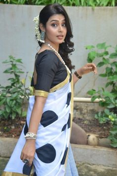 a woman in a blue and white sari