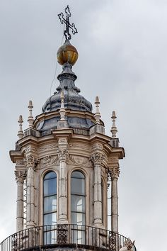 an ornate building with a weather vane on top