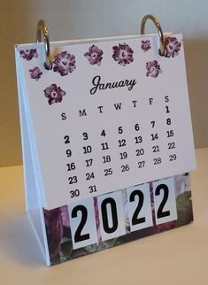 a calendar with flowers on it sitting on a table