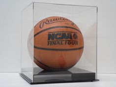 a basketball in a clear case on a black base with the words rawpen's final four printed on it