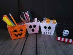 three baskets with different types of pens and pencils in them on a wooden table