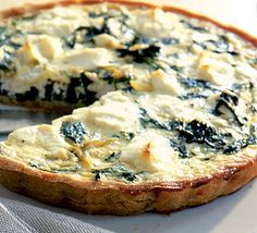 a cheese and spinach quiche on a plate