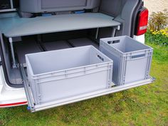 the back end of a van with two storage bins