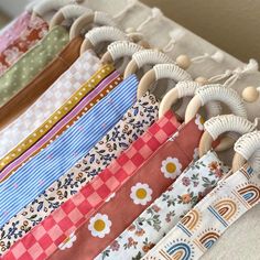 a close up of many different types of cloths on a table with wooden handles