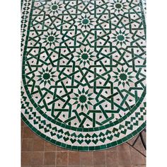 a green and white table sitting on top of a tiled floor