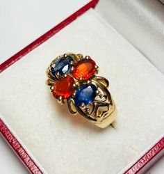 Beautiful Vintage 14k Yellow Gold Natural Sapphire and Orange Opal Ring 100% Genuine Sapphires and Orange Opals Beautiful and clean genuine Sapphire and Orange Opal Sapphire(s) 1.00CT Orange Opal(s) 1.00CT Total ring weight: 4.4GR 14K Yellow Gold Ring sizing available Free of Charge For more information regarding this item feel free to reach me so I can accommodate your needs. Thank you Gold Multi-stone Oval Sapphire Ring, Gold Multi-stone Sapphire Ring With Oval Shape, Gold Oval Sapphire Ring With Multi-stones, Classic Multi-stone Yellow Gold Gemstones, Classic Yellow Gold Multi-stone Gemstones, Classic Gold Multi-stone Sapphire Ring, Formal Multi-stone Sapphire Ring In Yellow Gold, Multicolor Heirloom Rings For Formal Occasions, Heirloom Multicolor Rings For Formal Occasions