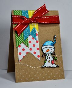 a handmade card with a snowman on the front and red ribbon around it