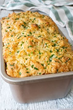 a casserole dish with cheese and parsley on top, ready to be eaten