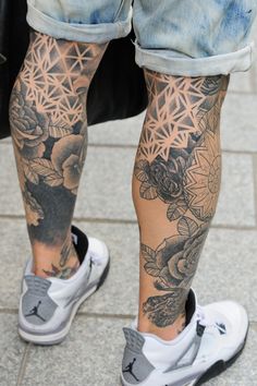 the legs and ankles of a person with tattoos on them