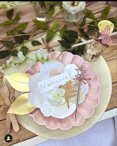 there is a plate with flowers on it and a place card in front of the plate