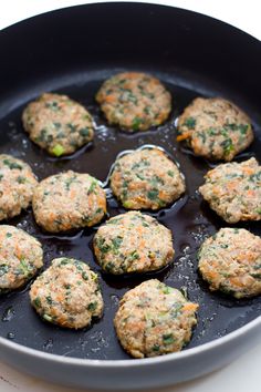 some meatballs are cooking in a pan on the stove top and ready to be cooked