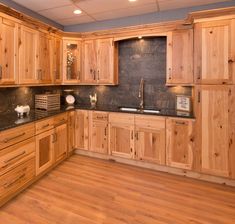 a kitchen with wooden cabinets and black counter tops