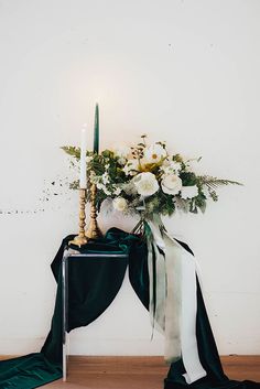 a table with flowers and a candle on it