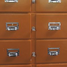 several brown drawers with chrome handles and knobs