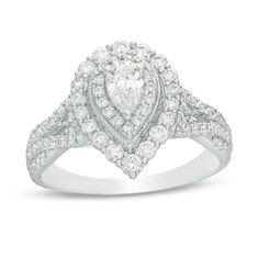 a pear shaped diamond ring set in 18k white gold with diamonds around the band