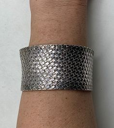 Awesome cuff bracelet is huge and is made entirely of sterling silver. The bracelet is thick/wide, and has sterling silver mesh that looks almost like chain mail making up the entire bracelet except for the ends, which have solid sterling silver bars going vertically to hold the mesh together.  Condition: Excellent! Stamped/Marked: 925  BA  INDONESIA Weight: 61 grams  Measurements: 6 1/2 inches around inside 1 1/4 inch wide gap/opening  Fits a 6 to 7 inch wrist *Cuff Band Width: 1 1/2 inches wide Wide Band Sterling Silver Bracelet, Gray Bracelet, Chain Mail, Wrist Cuffs, Nov 2, Silver Bars, Phoenix Az, Cuff Bracelet, Cuff Bracelets